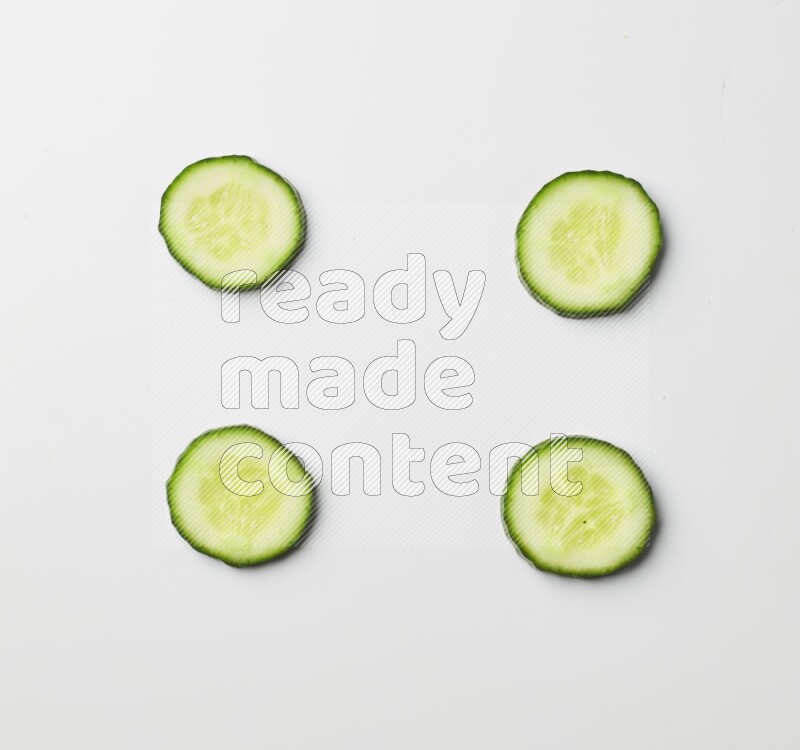 Multiple cucumber slices on white background