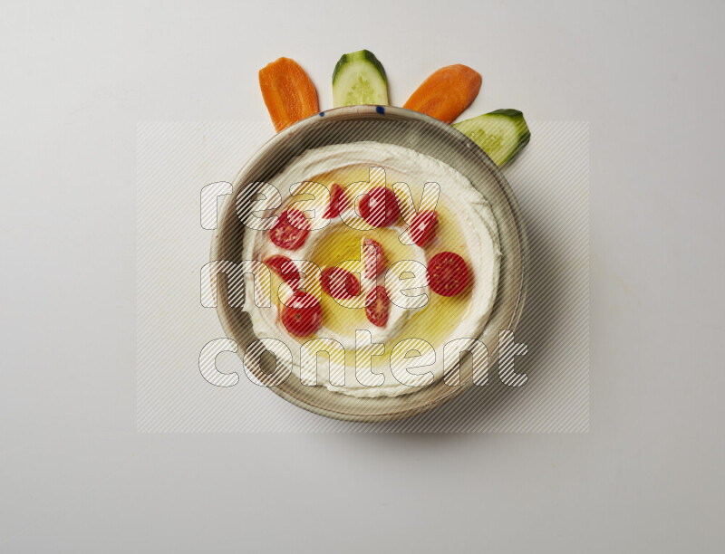 Lebnah garnished with cherry tomato in a grey pottery plate on a white background