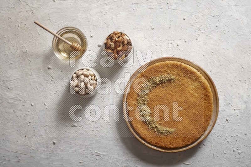 Konafa with nuts and honey in a light setup