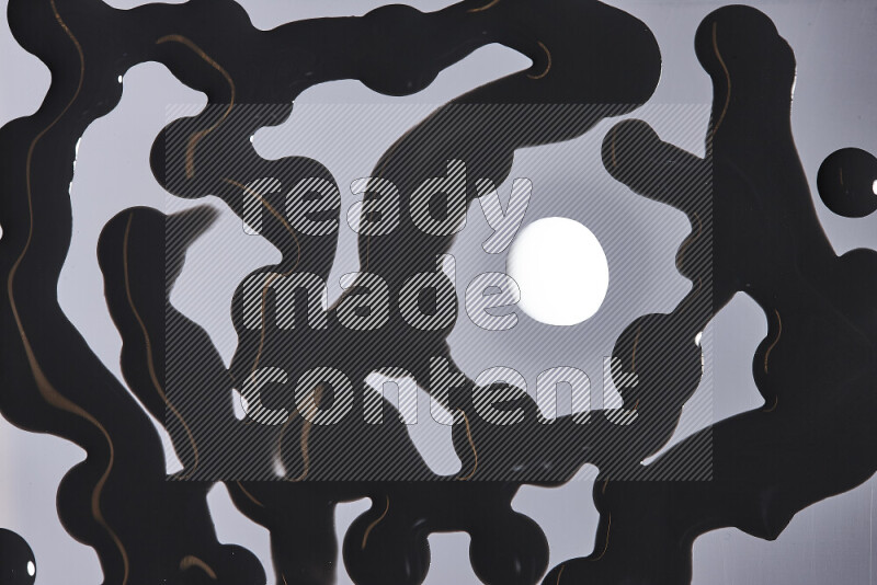 Close-ups of abstract white and black paint droplets on the surface