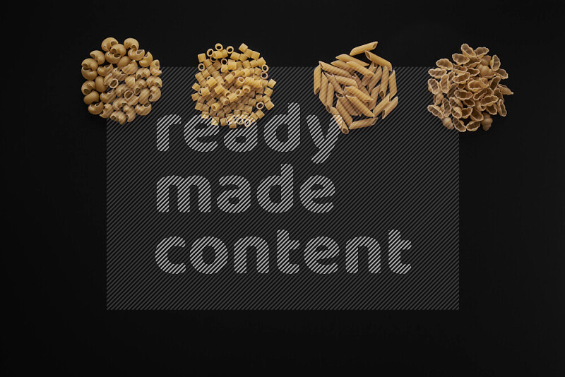 Different pasta types in 4 bunches on black background