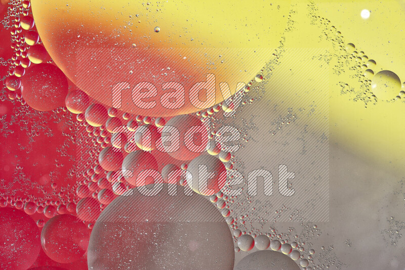 Close-ups of abstract oil bubbles on water surface in shades of yellow, red and brown