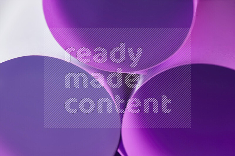The image shows an abstract paper art with circular shapes in varying shades of purple