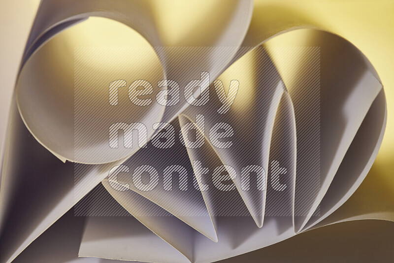An artistic display of paper folds creating a harmonious blend of geometric shapes, highlighted by soft lighting in warm tones