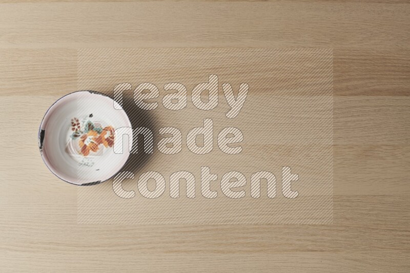 A vintage metal plate on light wooden background