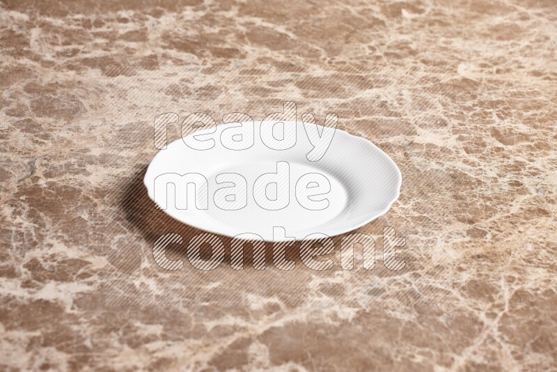 A white ceramic circular plate on beige marble background