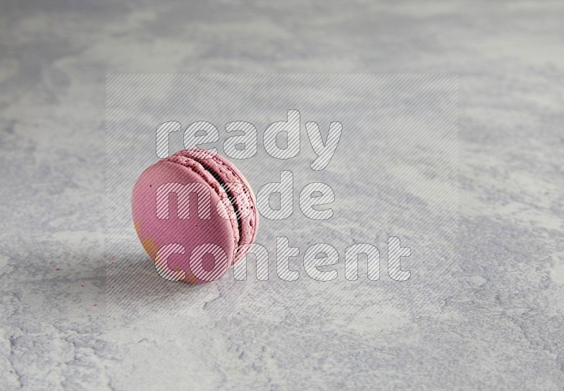 45º Shot of Purple Strawberry macaron on white  marble background