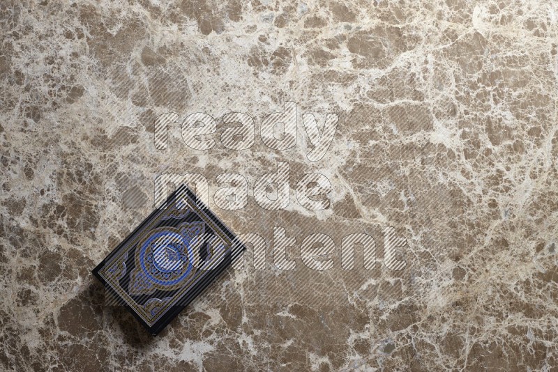 The holy quran on beige marble background