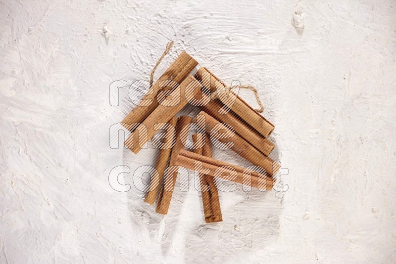 An unbounded stack of cinnamon sticks on white background