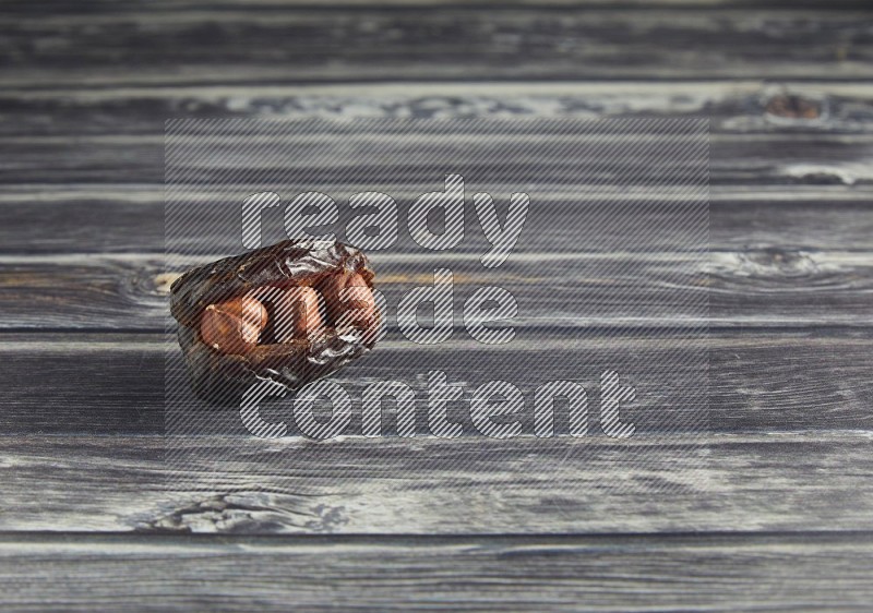 hazelnut stuffed madjoul date on a wooden grey background