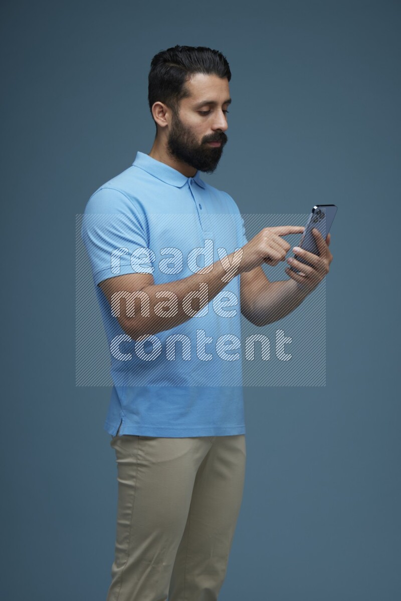 A man Swiping in a blue background wearing a Blue shirt