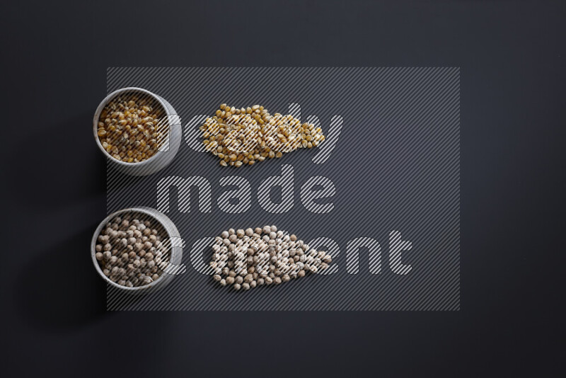 Legumes in pottery bowls on grey background