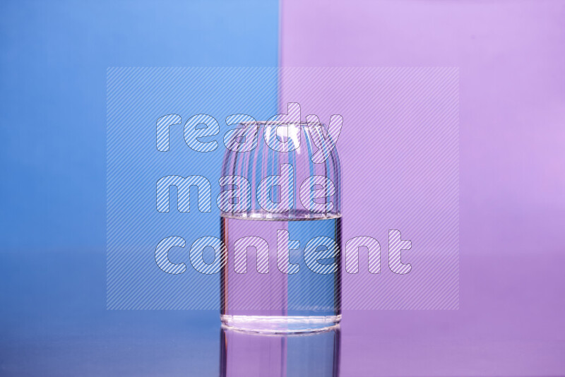 The image features a clear glassware filled with water, set against blue and light purple background