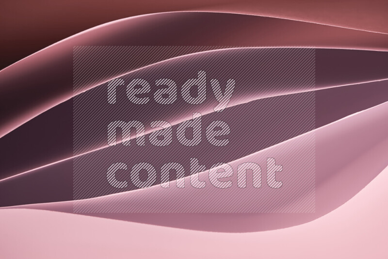 هذه الصورة تعرض تكوين فن الورق التجريدي مع منحنيات ورقية بتدرجات لونية دافئة مختلفة المكونه بواسطة الضوء الملون