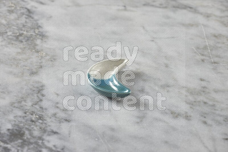 A pottery crescent plate on grey marble background