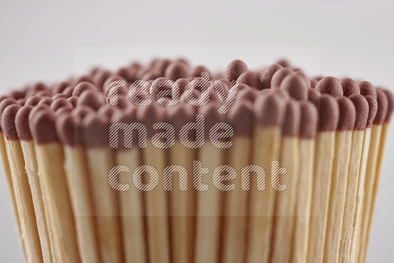 A close-up of a bundle of matches on grey background