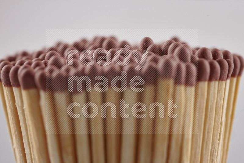 A close-up of a bundle of matches on grey background