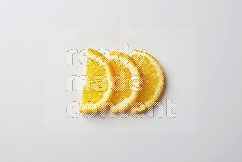 Three halves of an orange slices on white background