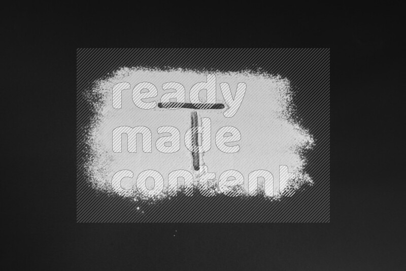 Alphabets written with powder on black background