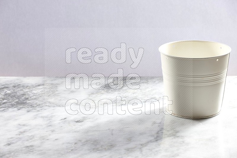 An Empty White Plant Pot on light grey Marble Flooring 45 degree angle
