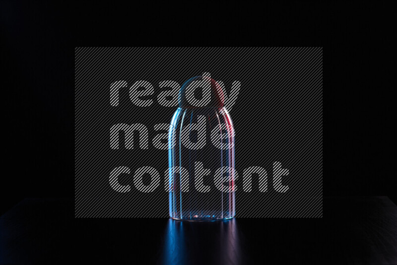 Glassware with rim light in red and blue against black background