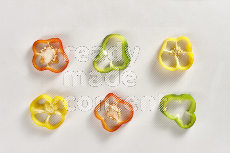 Assorted bell pepper slices on white background