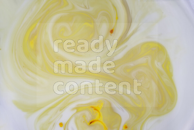 A close-up of abstract swirling patterns in yellow and white