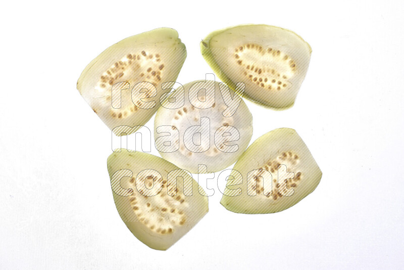 Guava slices on illuminated white background