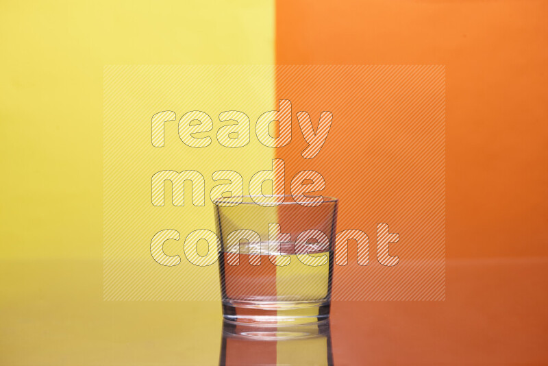 The image features a clear glassware filled with water, set against yellow and orange background
