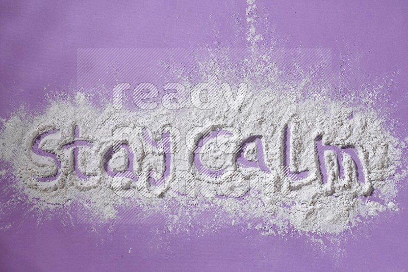 A sentence written with powder on purple background