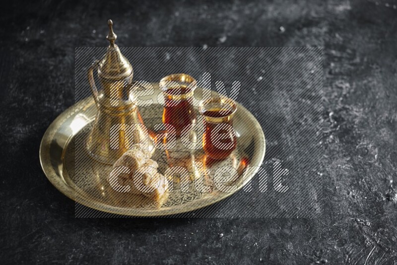 Golash with a drink on a metal tray in a dark setup