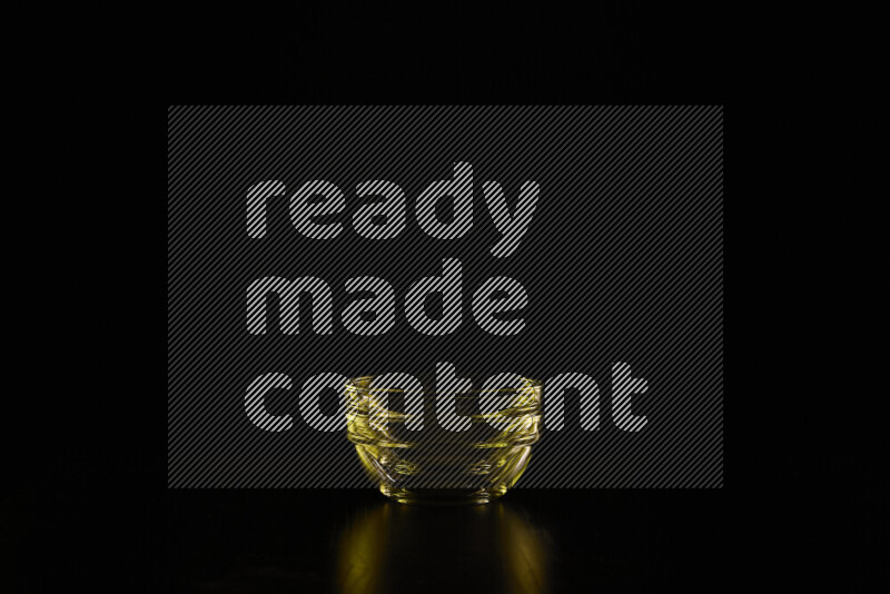 Glassware with rim light in yellow against black background