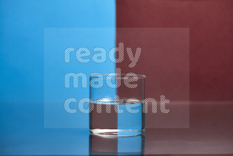 The image features a clear glassware filled with water, set against blue and dark red background