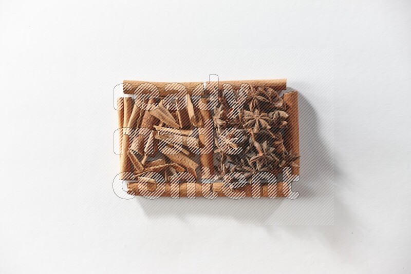 2 squares of cinnamon sticks full of star anise and cinnamon on white flooring