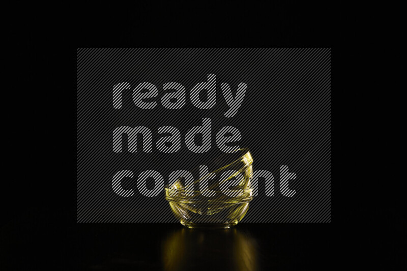 Glassware with rim light in yellow against black background