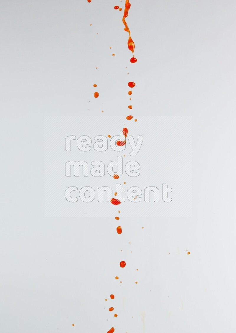 Orange liquid splash and drops on white background