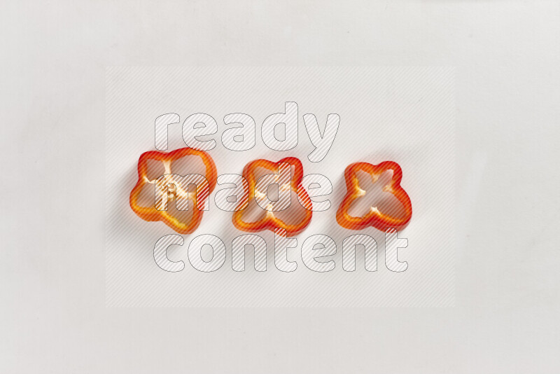 Red bell pepper slices on white background