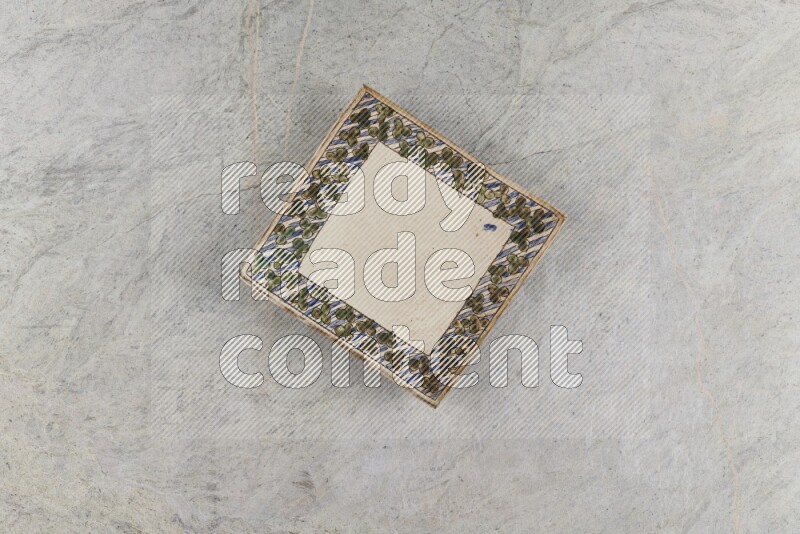 A decorative pottery plate on grey marble background