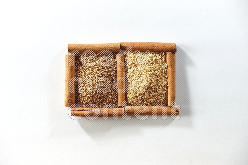 2 squares of cinnamon sticks full of mustard seeds and sesame on white flooring