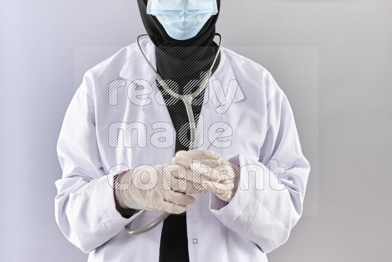 Female doctor wearing an abaya and medical attire in different positions
