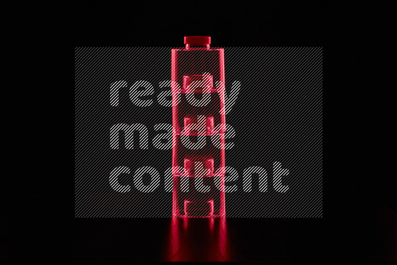 Glassware with rim light in red against black background