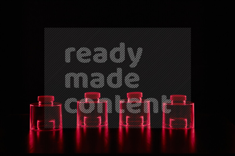 Glassware with rim light in red against black background