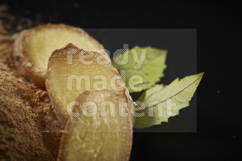 A bunch of ground ginger powder on black background