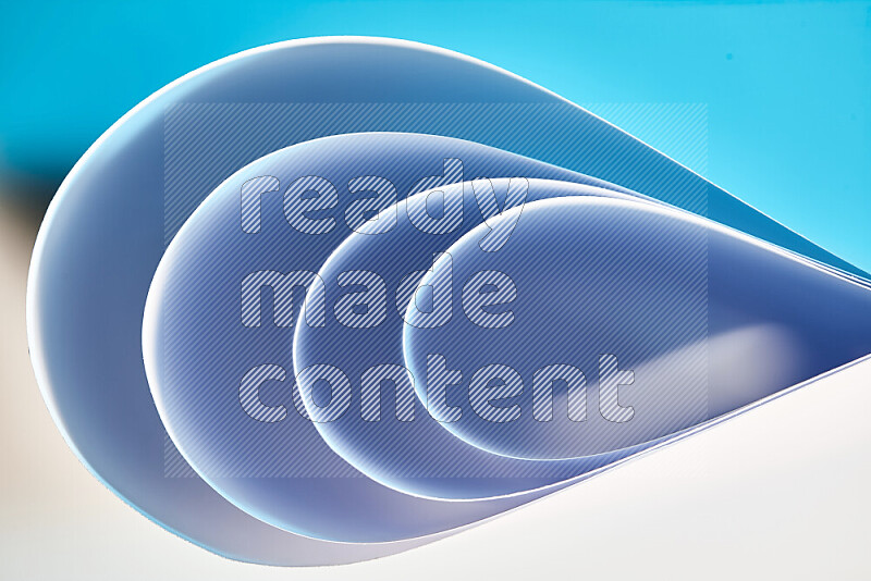 An abstract art of paper folded into smooth curves in blue gradients
