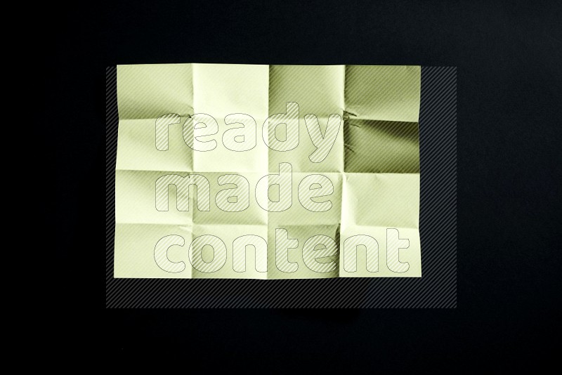 Yellow paper sheet on black background