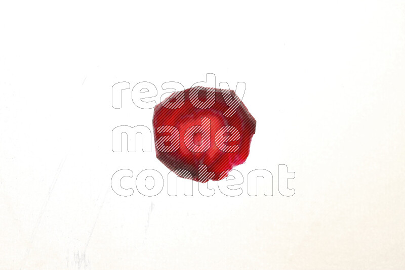 Beet slices on illuminated white background