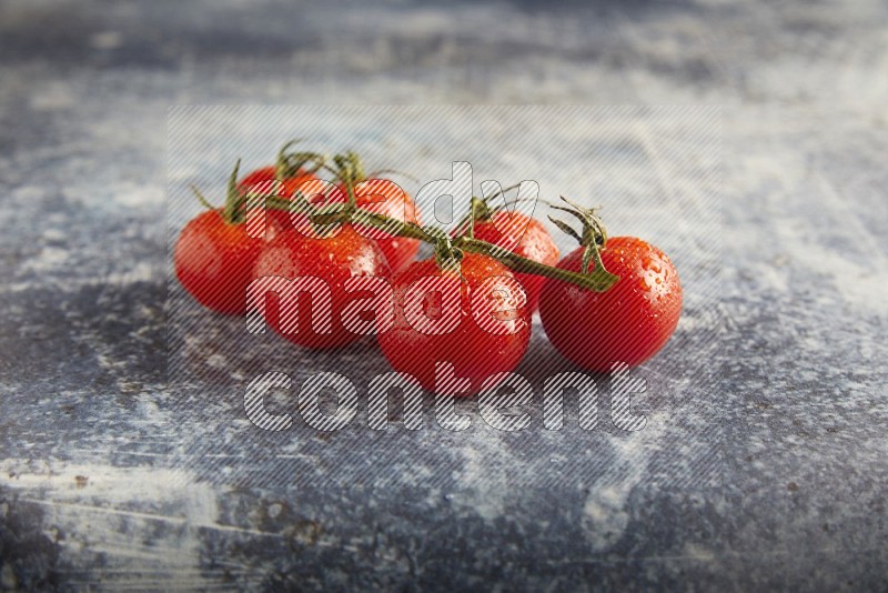 Red cherry tomato vein on a textured rusty blue background 45 degree