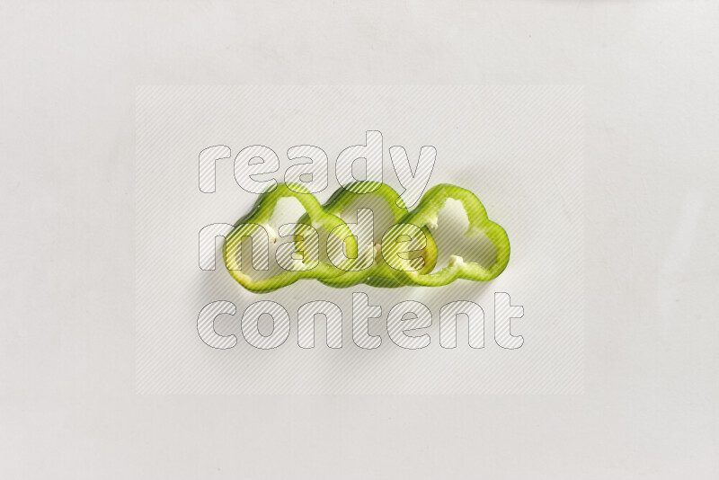 Green bell pepper slices on white background