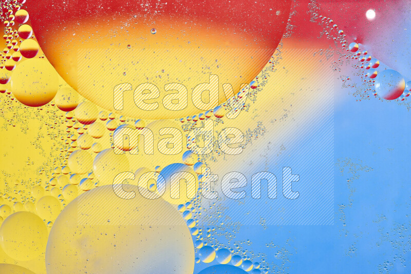 Close-ups of abstract oil bubbles on water surface in shades of yellow, red and blue