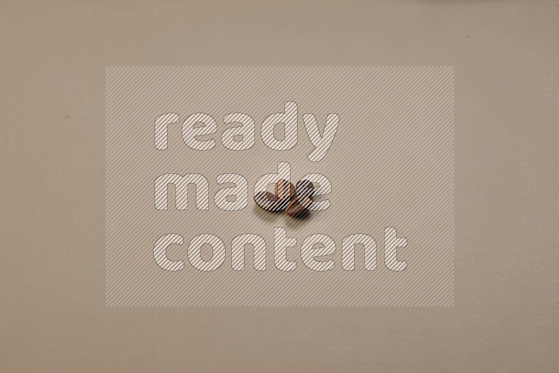 Roasted coffee beans on beige background
